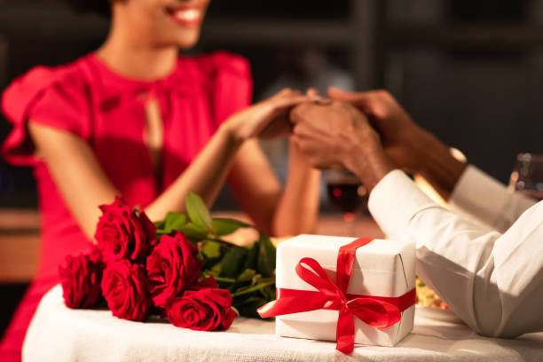 istock Unrecognizable Couple Holding Hands Having Date In Fancy Restaurant, Cropped 1201450001
