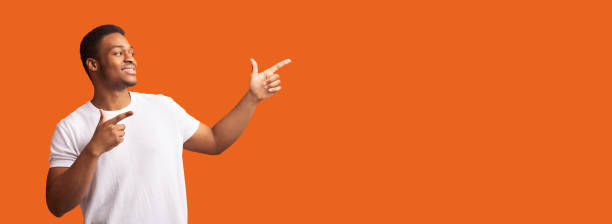 istock Black guy pointing at free space for promo 1201452942