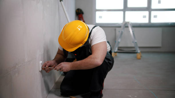 istock A man works with a screwdriver in a socket in draft apartment 1201454829
