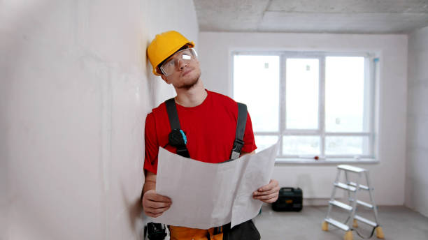 istock A tired man worker holding apartment plan and thinking about it 1201454846