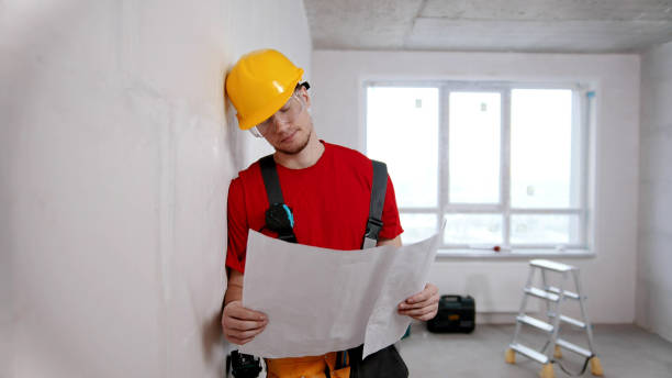 istock A tired man worker looking at the apartment plan 1201454871