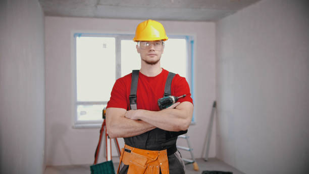istock A young fit man worker in draft apartment holding instrument 1201454939