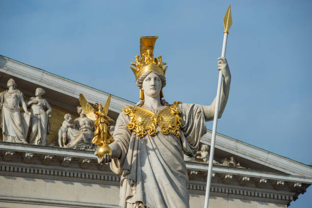 Pallas Athena statue Vienna, Austria - December 07, 2018: Vienna Parliament building with the Pallas Athene statue at the front. Built from 1874 to 1883 according the plans of architect Theophil Hansen in the Greek-Roman style the historical rooms are used as residence for the Austrian National and Federal council. ringstraße boulevard stock pictures, royalty-free photos & images