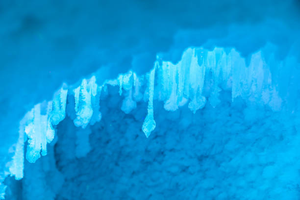 Icicles on the roof of a children's house in the evening in spring.