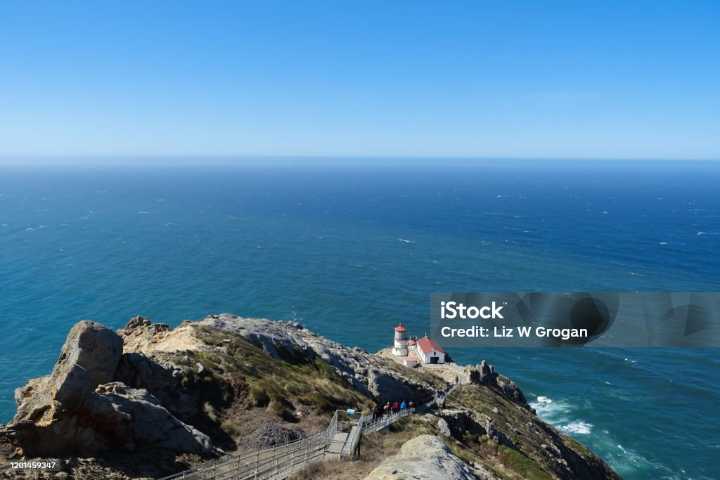 A steep staircase leads past the rocky terrain down to the Point Reyes lighthouse overlooking the Pacific Ocean in Northern California; landscape Point Reyes National Seashore Stock Photo