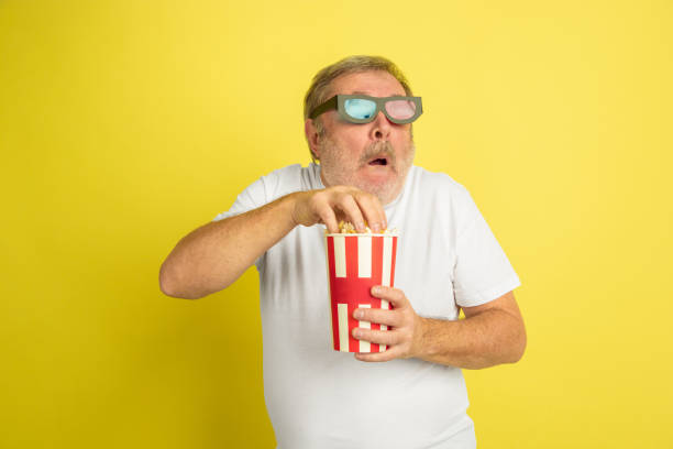 istock Caucasian senior man's portrait isolated on yellow studio background 1201460937