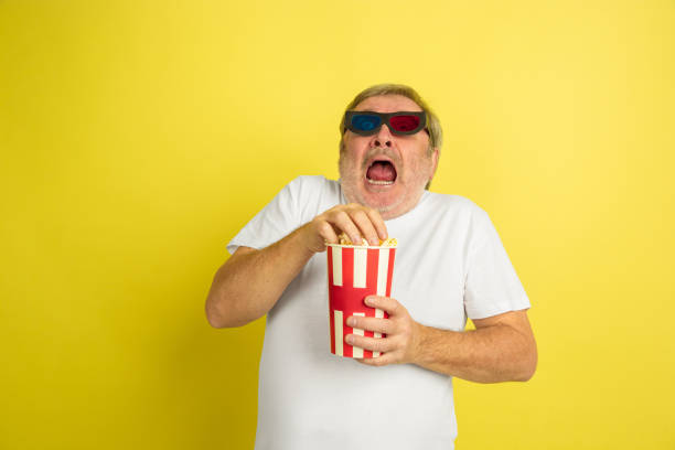 istock Caucasian senior man's portrait isolated on yellow studio background 1201460999