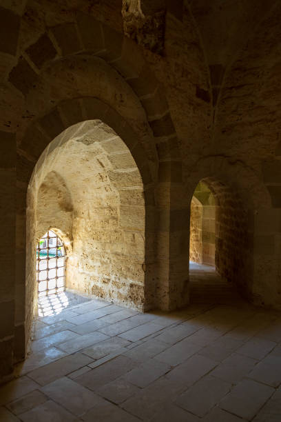 istock Ancient stone building with bright sunlight shining through arches 1201461289