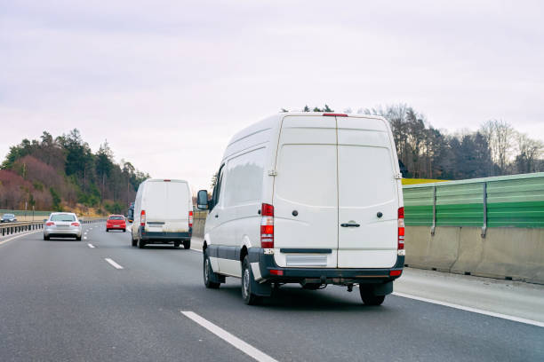 istock White Minivans in road European van transport 1201461329
