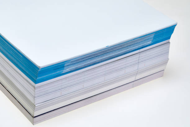 istock Stack of white and blue paper, books close up 1201463594