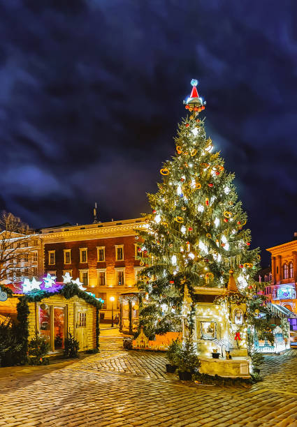 istock Xmas tree at Night Christmas market on Dome Square Riga 1201464591
