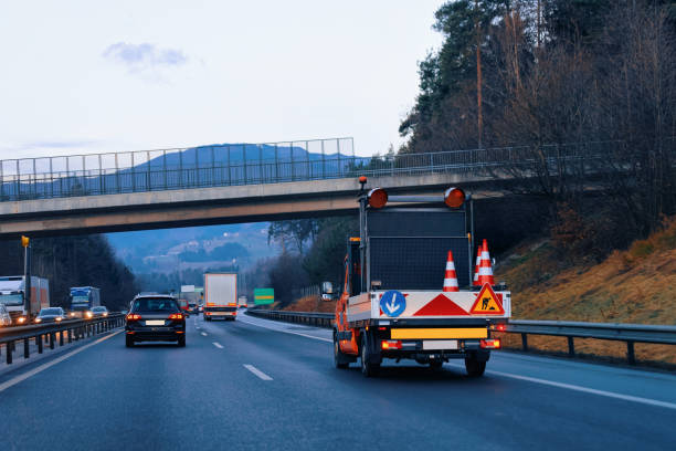 istock Truck carries arrow down left reflective direction road sign 1201465895