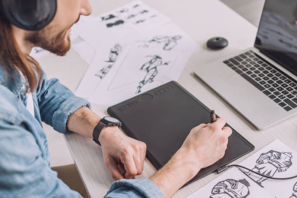 istock cropped view of animator in headphones using digital tablet 1201466774