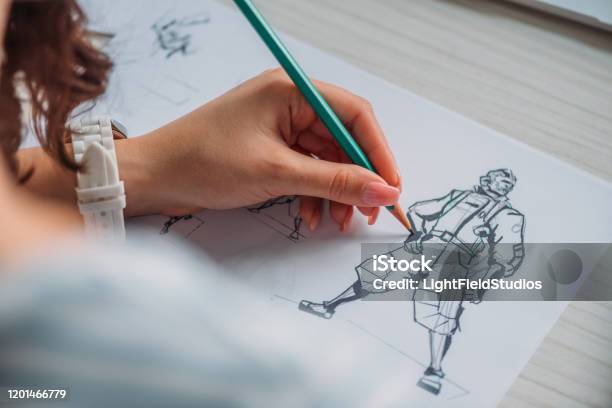 Selective Focus Of Illustrator Drawing Cartoon Character On Paper Stock Photo - Download Image Now