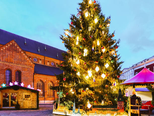 istock Xmas tree at Christmas market on Dome Square stalls Riga 1201467168