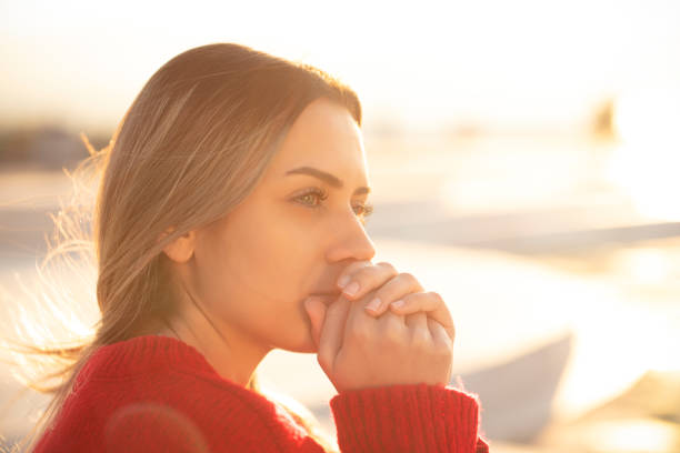 istock Thoughtful and lonely woman sitting on the bench 1201467407