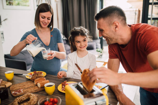 istock Pregnant mom having a breakfast with her husband and little daughter 1201468723