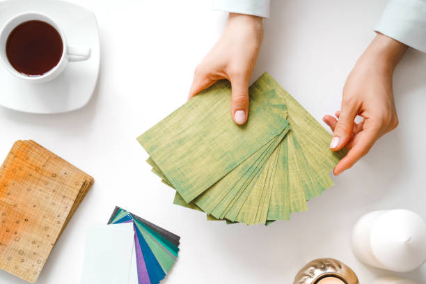 Woman hold metaphorical associative cards.