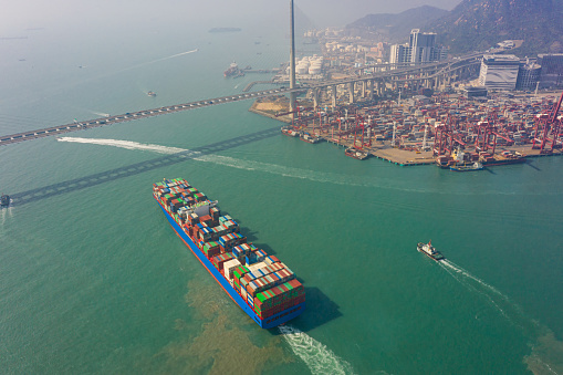Aerial view of international port with Crane loading containers in import export business logistics at Hong Kong in China