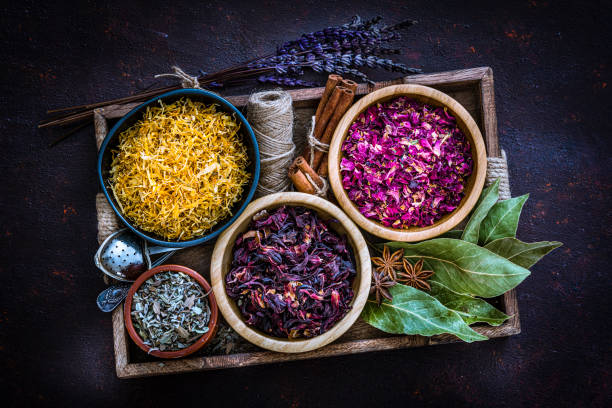 istock Various dried tea leaves and flowers shot from above on dark table 1201469958