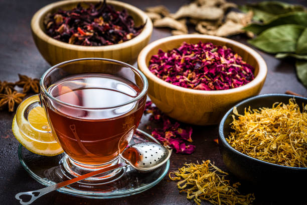 istock Tea cup with several dried tea leaves and flowers 1201469988
