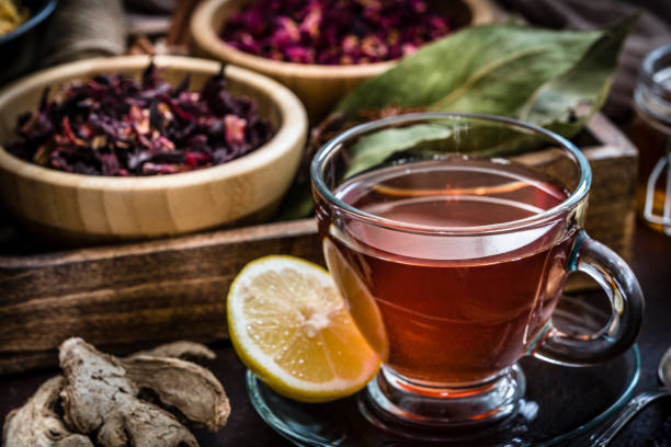 Tea cup with several dried tea leaves and flowers
