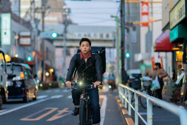 istock Man delivering food on bicycle 1201470143