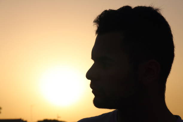 istock Sunset and silhouette of a man 1201473153