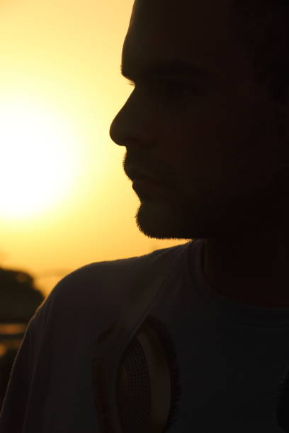 istock Sunset and silhouette of a man 1201473217