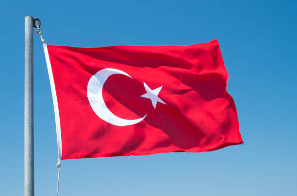 istock Turkish flag flutters against the blue sky. 1201473802