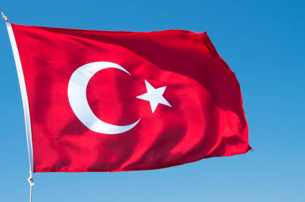 istock Turkish flag flutters against the blue sky. 1201473878