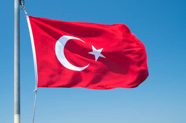 istock Turkish flag flutters against the blue sky. 1201473889