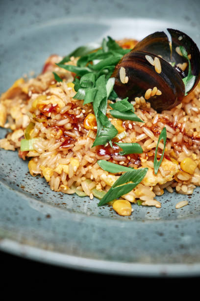 istock Risotto with mussels and corn in a blue plate 1201477999