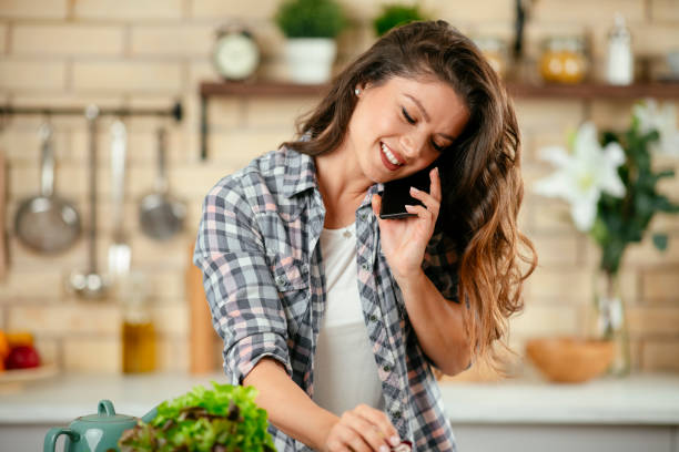 istock Young woman preparing food in kitchen 1201478019