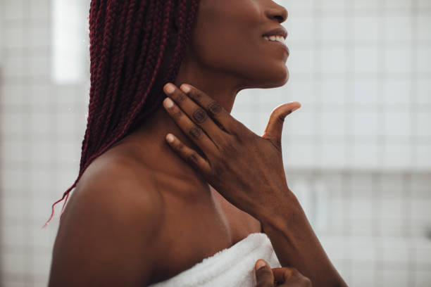 a woman touching her neck - moisturizer women cosmetics body imagens e fotografias de stock