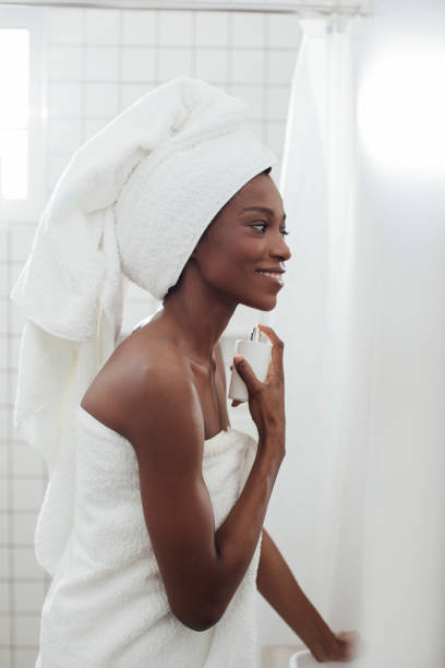 istock Woman Putting Perfume on her Neck 1201478349