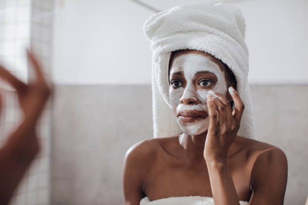 istock Woman Applying Cosmetic Face Mask 1201478387