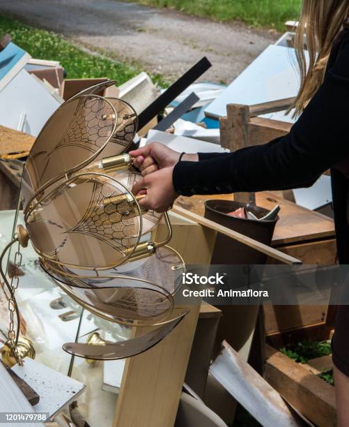 Woman Takes Lamp From Bulky Waste Stock Photo - Download Image Now - Garbage, Large, Waste Management