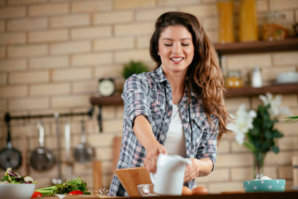 istock Young woman preparing food in kitchen 1201480168
