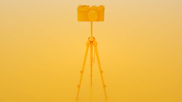 Photo studio concept. Camera and tripod on yellow background. 3d illustration.