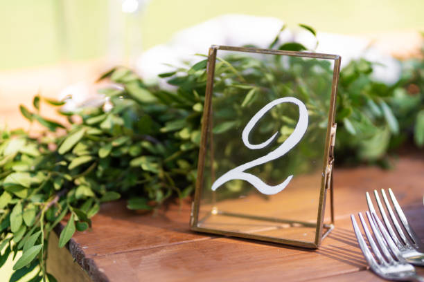 istock Preparing for an open-air party. Decorated with fresh flowers served tables. Table number. Decoration Details 1201483159