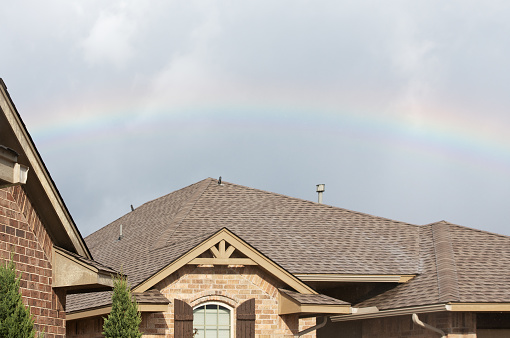 Rainbow over the roof of houses