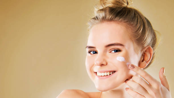 istock beautiful model applying cosmetic cream treatment on her face 1201485354