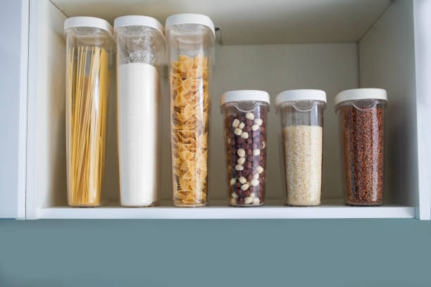 istock Stocked kitchen pantry with food - pasta, buckwheat, rice and sugar . 1201485801