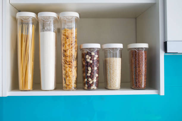 istock Stocked kitchen pantry with food - pasta, buckwheat, rice and sugar , side view. 1201485819