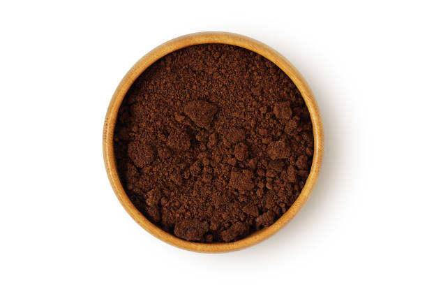 istock Coffee ground in wooden bowl on white background 1201485821