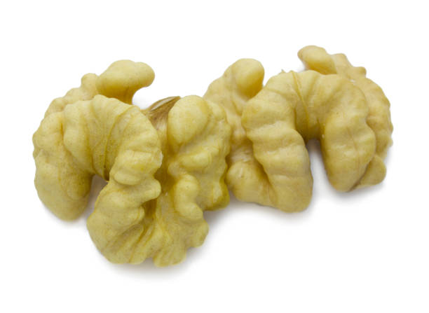 istock Two halves of walnut isolated on white background. Fruit of a nut. 1201487409