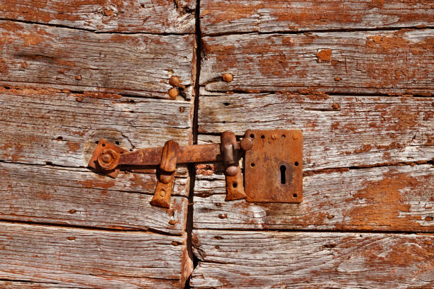 istock Old iron door latch on wooden door 1201489722