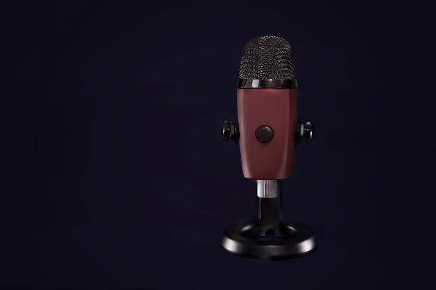 istock modern microphone on the black background, isolated on black 1201491397