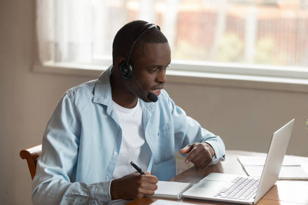 istock Concentrated biracial man in earphones study on laptop 1201492804